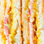 Close-up crispy air fryer cooked ham and cheese toastie with piccalilli.
