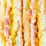 Close-up crispy air fryer cooked ham and cheese toastie with piccalilli.