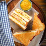Overhead air fryer cooked ham and cheese toastie with piccalilli.