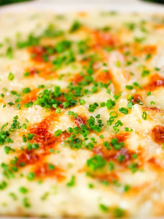 Close-up individual cheesy baked bean pasta bakes (bean mac and cheese).