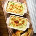 Overhead individual cheesy baked bean pasta bakes (bean mac and cheese).