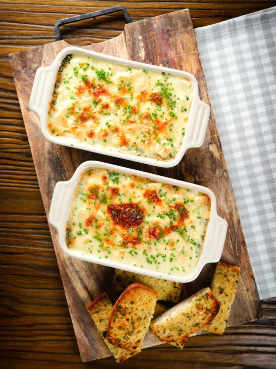Overhead individual cheesy baked bean pasta bakes (bean mac and cheese).