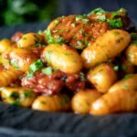 Close-up sausage gnocchi in a rich tomato sauce served.