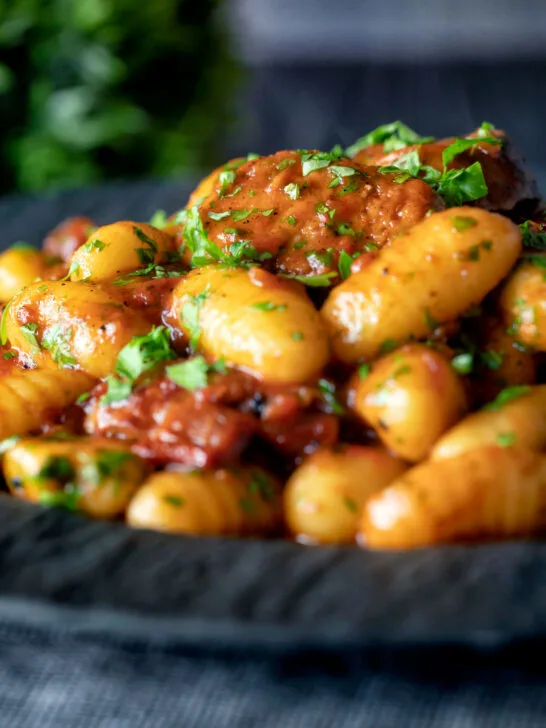 Close-up sausage gnocchi in a rich tomato sauce served.