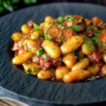 Sausage gnocchi in a rich tomato sauce served.