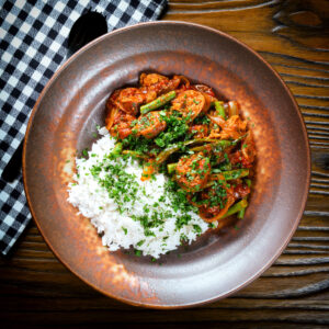 Indian-influenced beef & pork sausage curry with green beans served with plain rice and coriander.