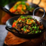 Indian-influenced chicken, mushroom and tomato curry served with naan bread.