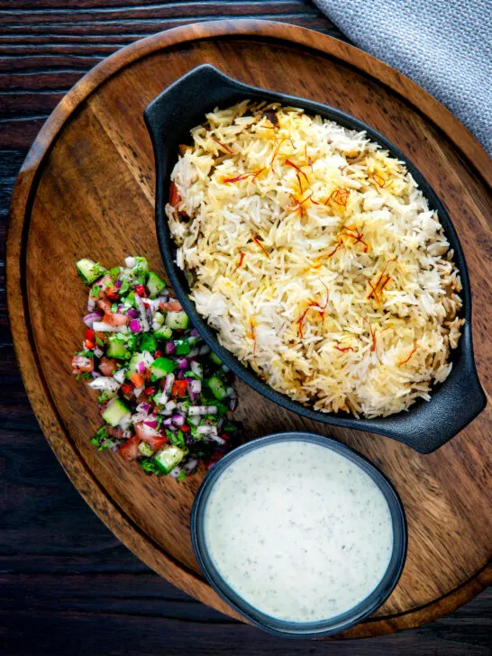 Baked vegan mushroom biryani served with mint raita and kachumber salad.