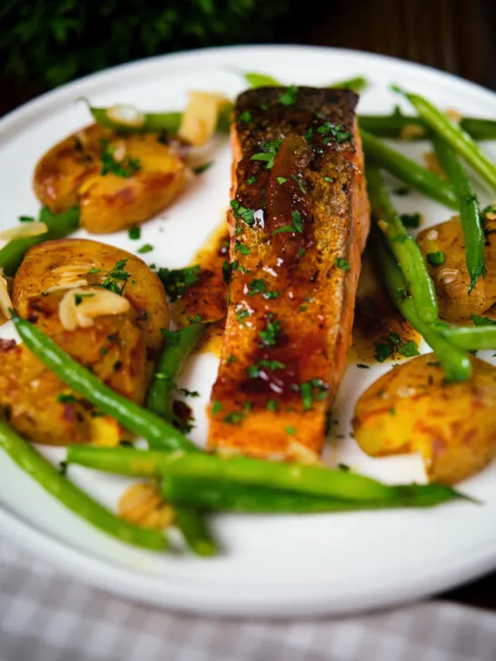 Orange and marmalade glazed salmon with roasted new potatoes and green beans.