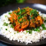 Andhra style chicken curry (kodi kura) served with Basmati rice.