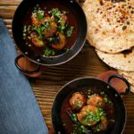 Overhead Kashmiri meatball curry, Lamb rista in a spicy saffron gravy.