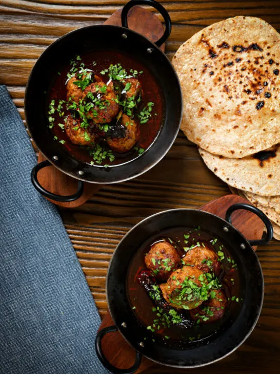 Overhead Kashmiri meatball curry, Lamb rista in a spicy saffron gravy.