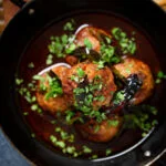 Overhead close-up Kashmiri meatball curry, Lamb rista in a spicy saffron gravy.