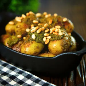 Brown butter and basil pesto baby potatoes garnished with toasted pine nuts.