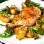 Roasted chicken legs with lemon and thyme served with pesto potatoes and broccoli.
