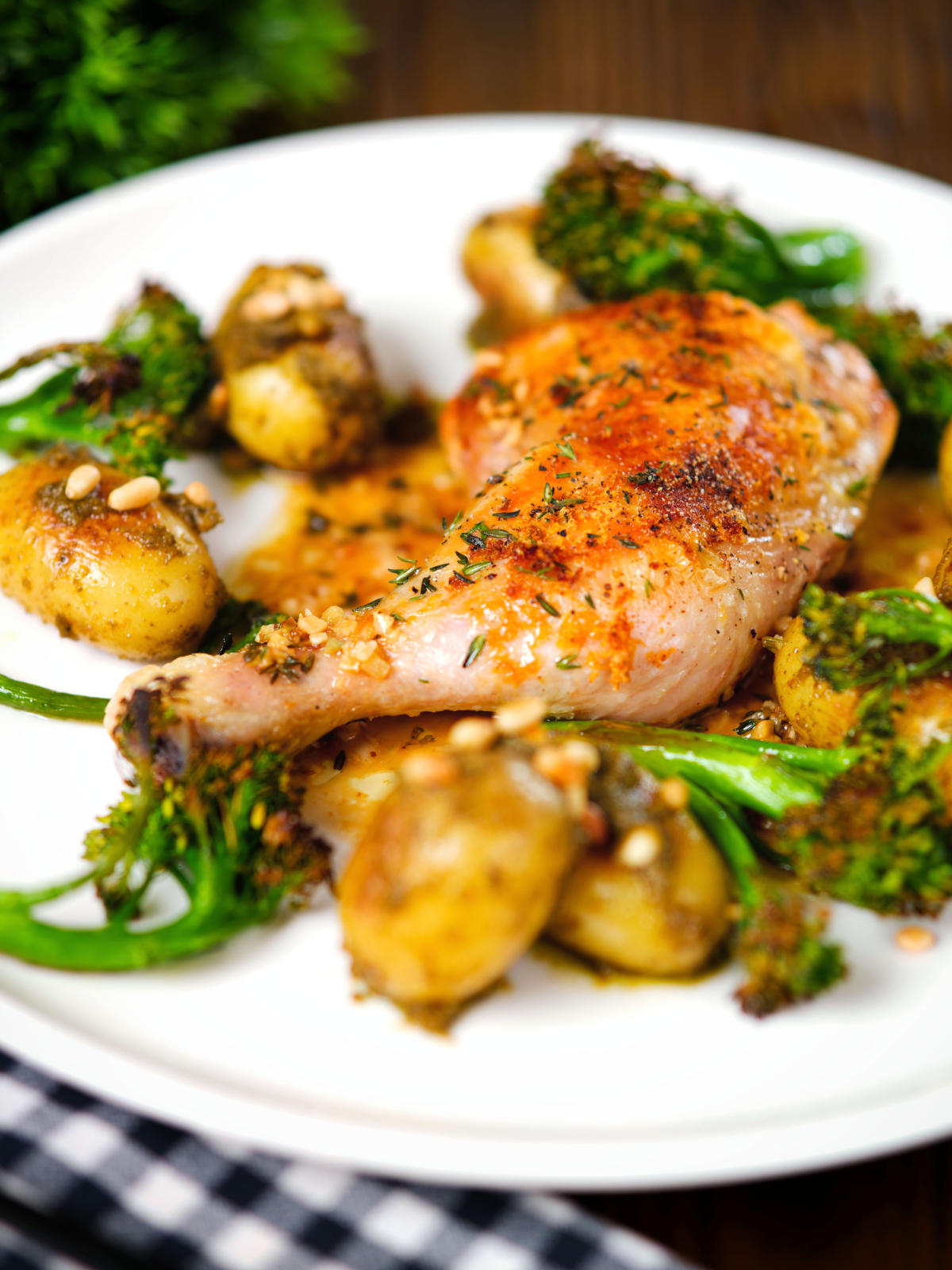 Roasted chicken legs with lemon and thyme served with pesto potatoes and broccoli.