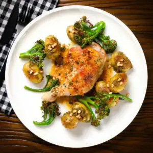 Cold pan roasted chicken legs with lemon and thyme served with pesto potatoes and broccoli.