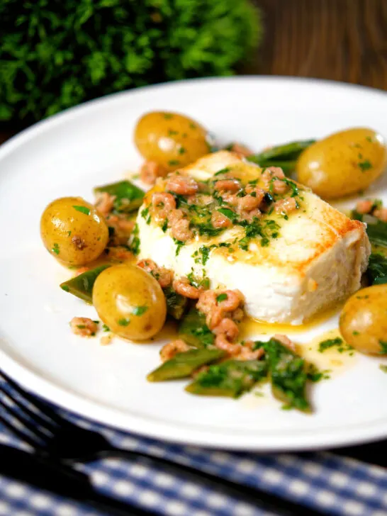 Roasted halibut with a potted shrimp and vermouth sauce, new potatoes and runner beans.