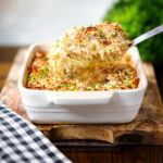 Baked cheesy chicken and bacon gratin with snipped chives.