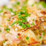 Close-up cheesy chicken, bacon and potato gratin.