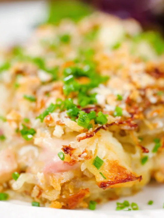 Close-up cheesy chicken, bacon and potato gratin.