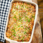 Cheesy chicken, bacon and potato gratin in a baking dish.
