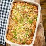 Cheesy chicken, bacon and potato gratin in a baking dish.