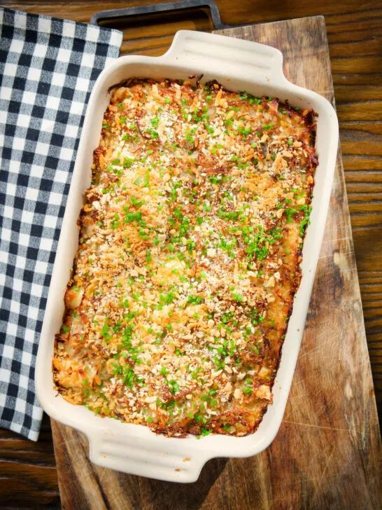 Cheesy chicken, bacon and potato gratin in a baking dish.