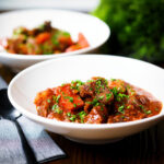 Filipino beef mechado with carrots and potatoes in a tomato sauce.