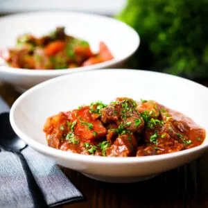 Filipino beef mechado with carrots and potatoes in a tomato sauce.