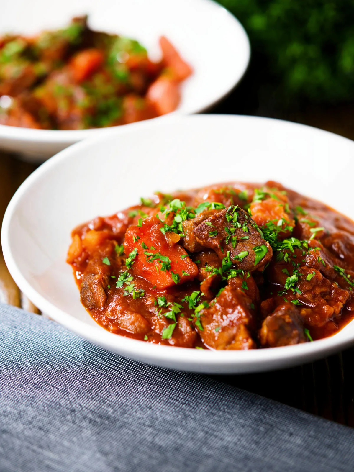 Filipino beef mechado stew with carrots and potatoes in a tomato sauce.