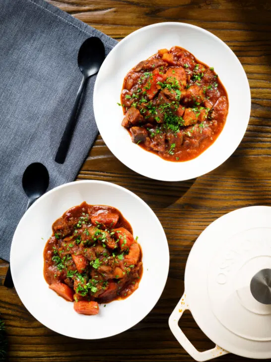 Overhead Filipino beef mechado stew with carrots and potatoes in a tomato sauce.