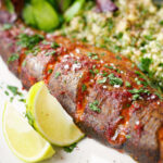 Close-up harissa baked/roasted rainbow trout with herbed bulgur wheat.