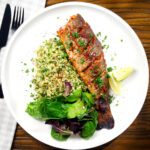 Overhead harissa baked/roasted rainbow trout with herbed bulgur wheat.