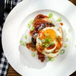 Overhead Hawaiian loco moco: beef patty, white rice, gravy and a fried egg.