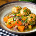 Minted lamb stew with dumplings, swede and carrots.