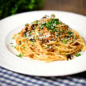 Pasta (spaghetti) foriana with walnuts, pine nuts and raisins garnished with parsley.