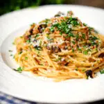 Pasta foriana with walnuts, pine nuts and raisins garnished with parsley.