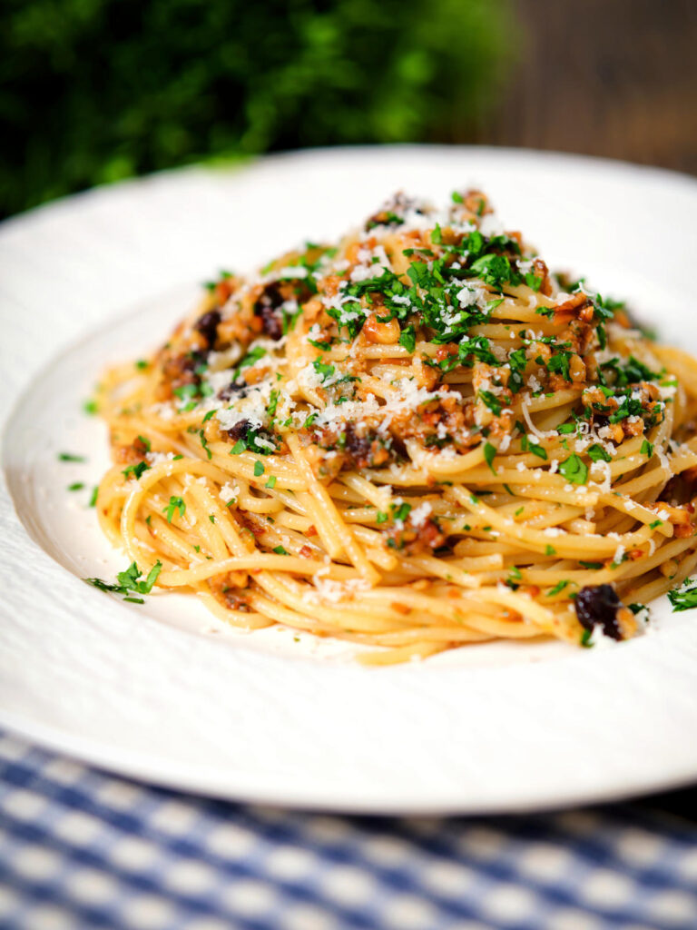 Pasta foriana with walnuts, pine nuts and raisins garnished with parsley.