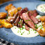 French soubise (onion sauce) with bavette steak and crushed roasted potatoes.