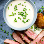 Overhead close-up French soubise (onion sauce) with bavette steak.