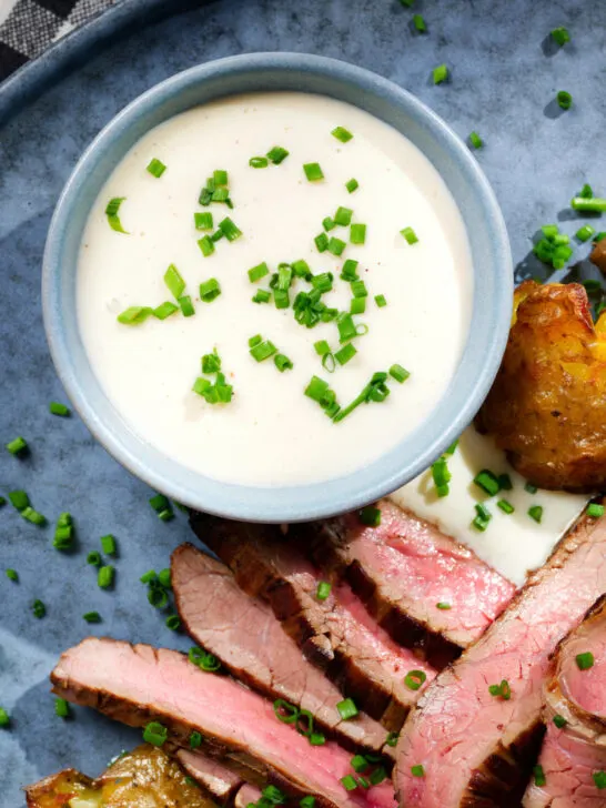 Overhead close-up French soubise (onion sauce) with bavette steak.