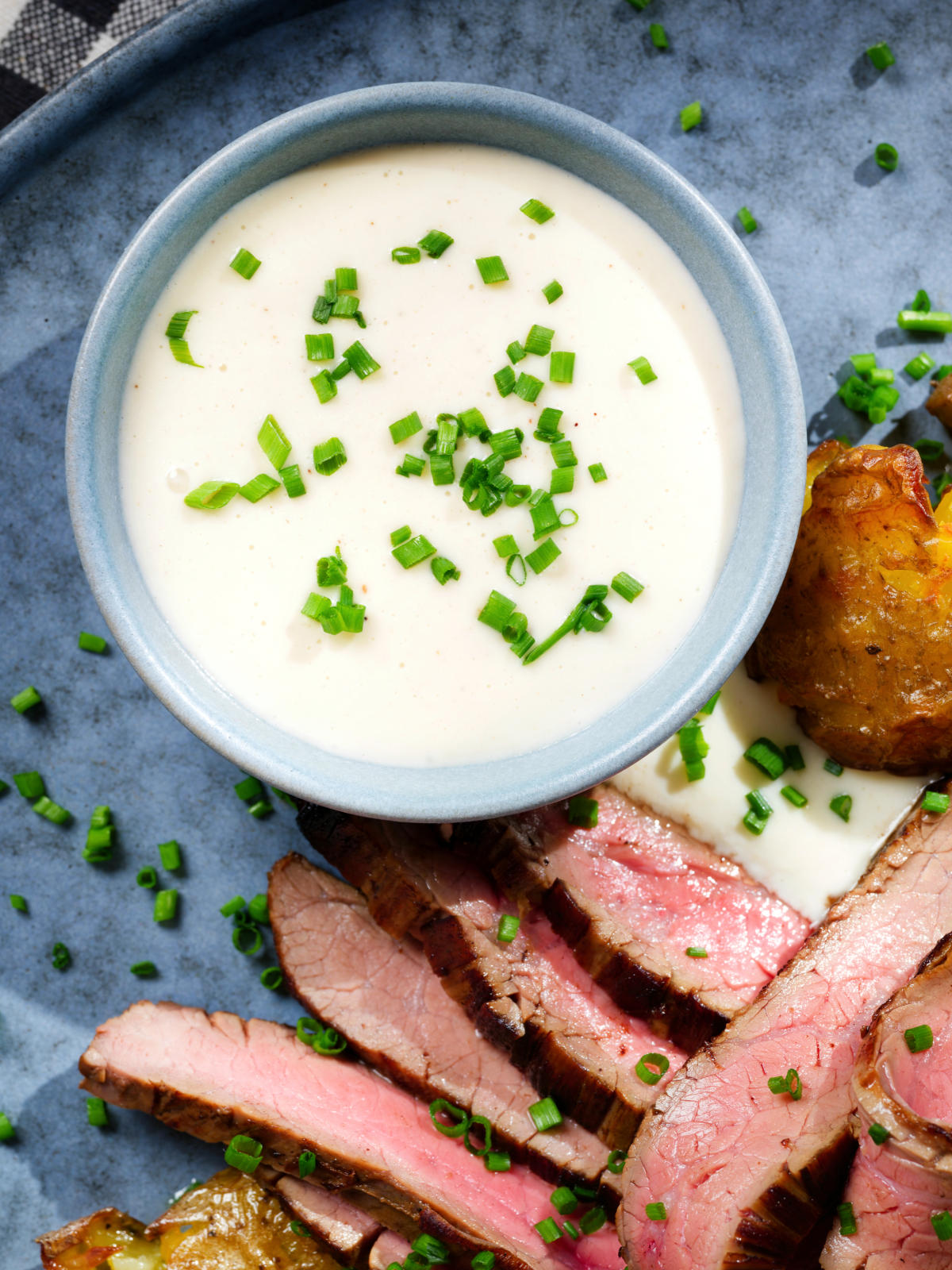 Overhead close-up French soubise (onion sauce) with bavette steak.