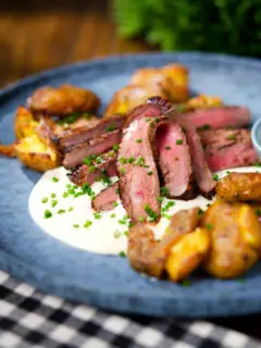 Marinated steak bavette (Flank Steak) served with soubise and crushed potatoes.
