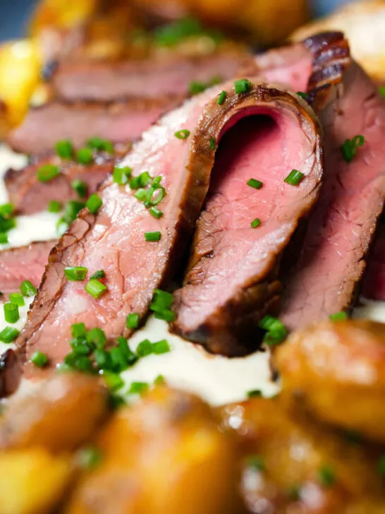 Close-up marinated steak bavette (Flank Steak) served with soubise and crushed potatoes.