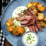 Overhead marinated steak bavette (Flank Steak) served with soubise and crushed potatoes.