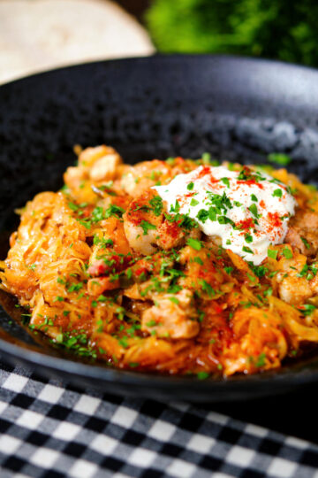 Hungarian székelykáposzta: pork belly and sauerkraut stew served with sour cream and bread.
