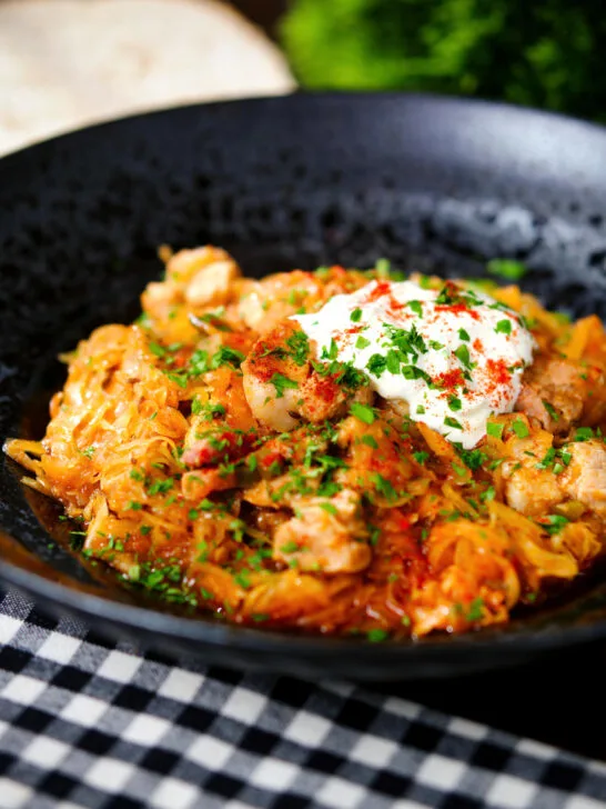 Hungarian sz&eacute;kelyk&aacute;poszta: pork belly and sauerkraut stew served with sour cream and bread.