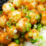 Overhead close-up Hong Kong fish ball curry with rice and spring onions.