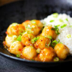 Hong Kong fish ball curry with rice and spring onions.